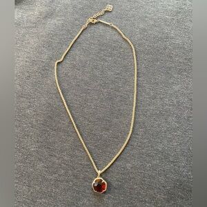 Elegant Gold Necklace with Red Pendant